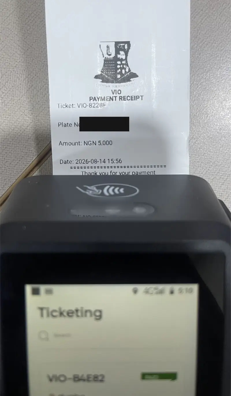A printed VIO payment receipt showing ticket number, amount of NGN 5,000 and date. Plate number redacted.
